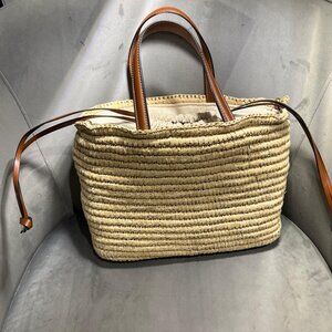 ZARA raffia bag featuring leather details and handles.
